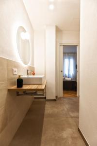 a bathroom with a sink and a mirror at Boccaccio Apartment 3 in Ravenna