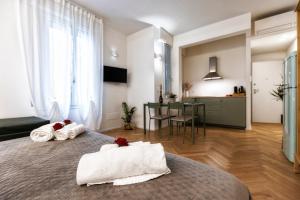 a bedroom with a bed with towels on it at Boccaccio Apartment 3 in Ravenna