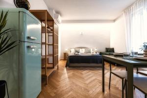 a bedroom with a bed and a table in a room at Boccaccio Apartment 3 in Ravenna