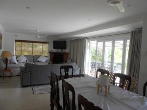 a living room with a table and a couch at Chickpea Villa in Bergview