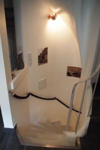 a staircase in a building with paintings on the wall at Petit Paris - Oasis in Marais in Paris