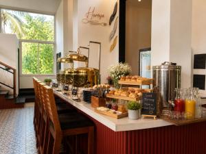 a bakery with a counter with bread and pastries at Dimaru Boutique Hotel in Calangute