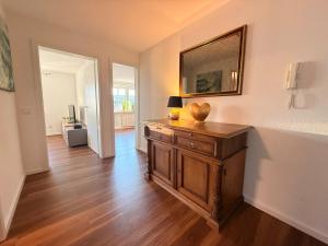 a living room with a wooden dresser in a room at Zwischen Donau & Kurpark in Bad Abbach