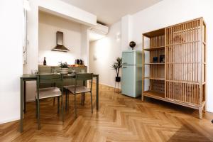 a kitchen and dining room with a table and a refrigerator at Boccaccio Apartment 3 in Ravenna +85 photos