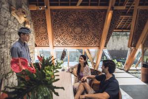 a group of three people sitting in a room at Kaamala Resort & Spa Ubud by Ini Vie Hospitality in Ubud