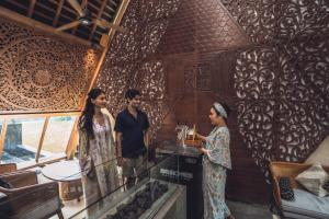 a group of people standing around a counter in a room at Kaamala Resort & Spa Ubud by Ini Vie Hospitality in Ubud +44 photos