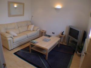 a living room with a couch and a coffee table at Earle House Serviced Apartments in Crewe