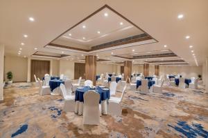 a banquet hall with white tables and chairs in a room at Keys Select By Lemon Tree Hotels, Chirang in Bongaigaon