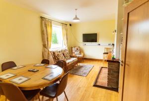 a dining room with a table and a living room at Beentee View - Cahersiveen in Cahersiveen