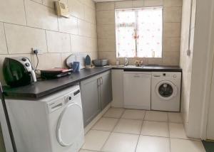 a kitchen with a sink and a washing machine at Beentee View - Cahersiveen in Cahersiveen
