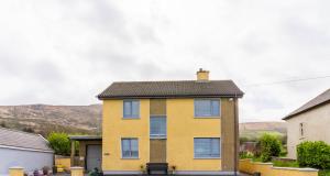 a yellow house with a black roof at Beentee View - Cahersiveen in Cahersiveen