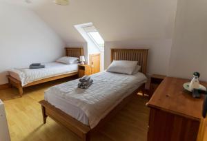 a bedroom with two beds and a window at 1 Bray Head View in Portmagee
