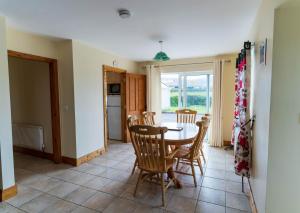 a kitchen and dining room with a table and chairs at 1 Bray Head View in Portmagee