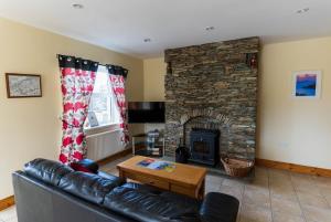 a living room with a couch and a fireplace at 1 Bray Head View in Portmagee