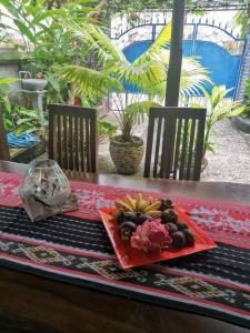 a table with a plate of fruit on a table at Villa Murni in Lovina