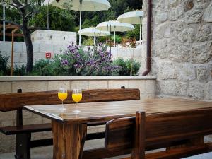 two glasses of wine sitting on a wooden table at Villa Maranta in Slano