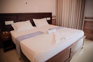 a bed with two stethoscopes on top of it at Hotel Jebasakthy in Kanyakumari