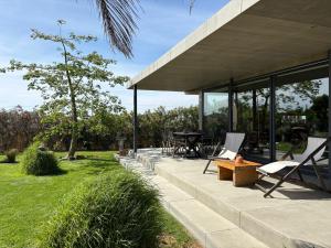 a patio with chairs and a table in a yard at Isabelina Stays near Doñana & the Coast in Sanlúcar de Barrameda