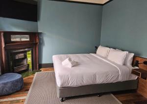 a bedroom with a bed and a fireplace at Mercantile Hotel in Sydney +7 photos