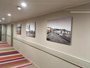 a hallway with art on the walls at Hôtel Le Royal Promenade des Anglais in Nice