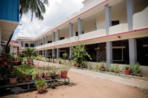 a courtyard of a building with potted plants at Hotel Jebasakthy in Kanyakumari