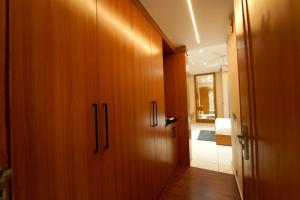 a hallway with wooden cabinets and a hallway leading to a bathroom at Hotel the republic in Zirakpur +4 photos
