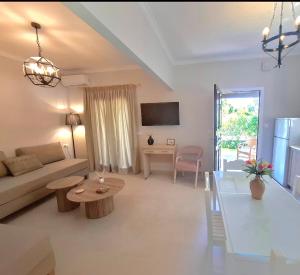 a living room with a couch and a table at Villa Tina Country Beach Apartments in Acharavi
