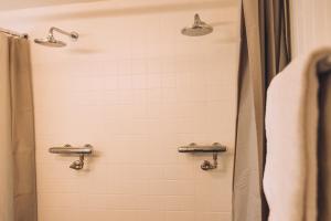 a shower with two lights and a shower curtain at Portierswoning Vaeshartelt in Maastricht +17 photos