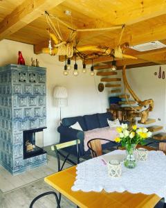 a living room with a table and a couch at Gliniana Chata in Zawoja