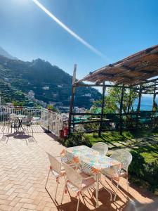 a patio with a table and chairs with a view at Antico Borgo in Minori