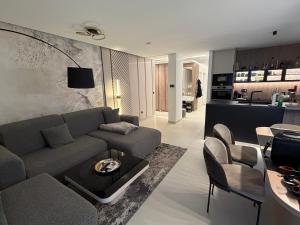 a living room with a couch and a table at Pearl Garden in Primošten