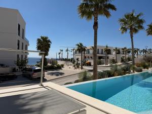 a view of a resort with a swimming pool and palm trees at Pearl Garden in Primošten