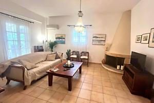 a living room with a couch and a coffee table at Castelli Retreat in Spetses