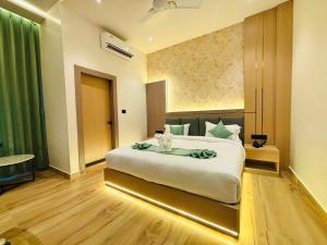 a bedroom with a large bed in a room at Regal Havens in Jorhat +6 photos