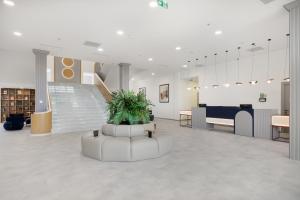 a large room with a plant in the middle at Academy by Ambassadori in Kachretʼi +73 photos