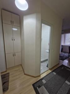 an empty room with a sliding glass door and a bathroom at Rystavi in Rustavi