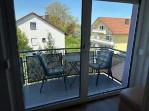 a room with a window with two chairs on a balcony at Appartementhaus Silke in Bad Füssing