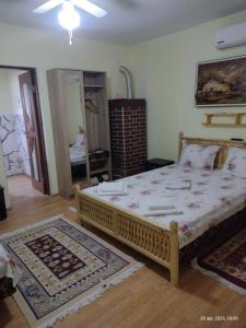 a bedroom with a large bed in a room at Casa de vacanta ,,Puiu & Nelly,, in Sulina