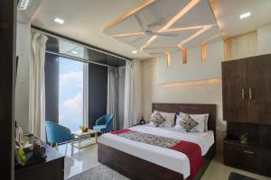 a bedroom with a bed and a large window at Hotel Priyaj Newly Built with Luxury Restaurant in Jaipur +77 photos