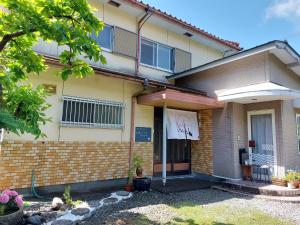 a building with a sign on the front of it at ゲストハウス凪季のやど in Nachikatsuura