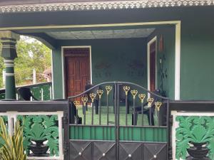 a front door of a house with a gate at Ceylona Homestay in Kurunegala