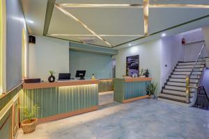 an office with a reception desk and stairs at Hotel Priyaj Newly Built with Luxury Restaurant in Jaipur