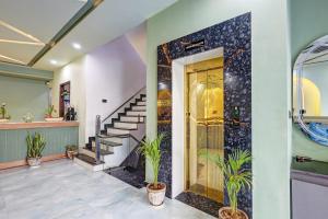 a hallway with a staircase and a door with plants at Hotel Priyaj Newly Built with Luxury Restaurant in Jaipur