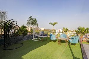 a balcony with a playground with chairs and a table at Hotel Priyaj Newly Built with Luxury Restaurant in Jaipur