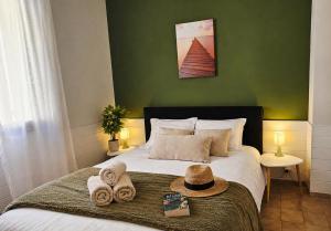 a bedroom with a bed with towels and a hat on it at Residence Arinella in Farinole +132 photos