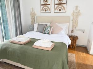 a bedroom with a bed with two towels on it at FINELINE Villa in Limassol +34 photos