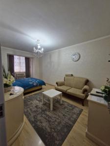 a living room with a bed and a couch at Rystavi in Rustavi