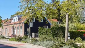 a black house on the side of a street at Studio@Domburg in Domburg
