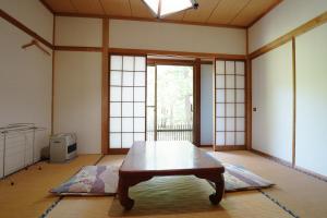 a room with a table in the middle of a room at Yamano Hidaya in Matsumoto