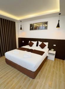a bedroom with a large bed in a room at Khaosok Unseen Resort in Khao Sok National Park